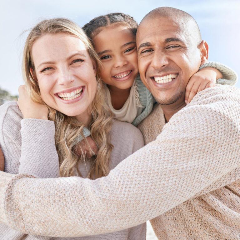 smiling married couple bonding with daughter beach adopted little girl embracing her parents beachside vacation happy husband wife enjoying free time with their child 1